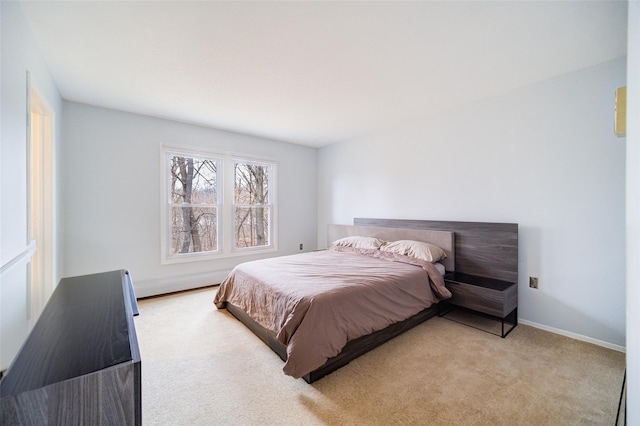 bedroom featuring light carpet