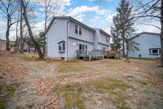 rear view of house featuring a deck