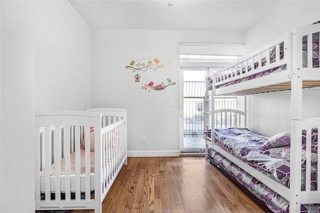 bedroom with dark hardwood / wood-style flooring