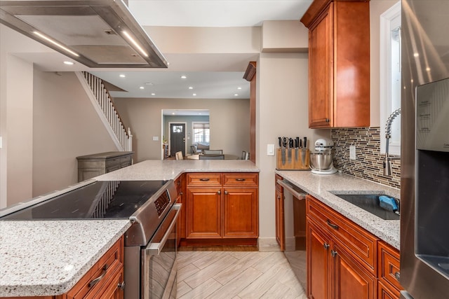 kitchen with stainless steel appliances, light stone countertops, sink, and decorative backsplash