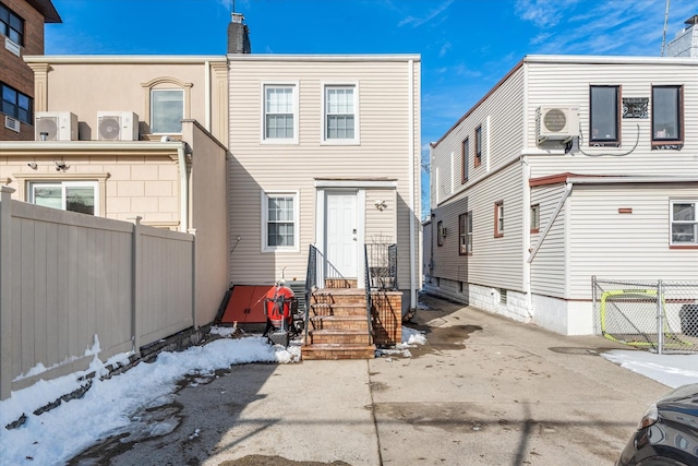 snow covered property featuring ac unit