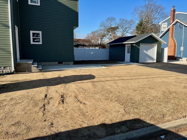 view of home's exterior featuring a garage and an outbuilding