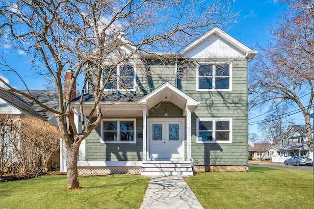 view of front of house with a front yard and a chimney