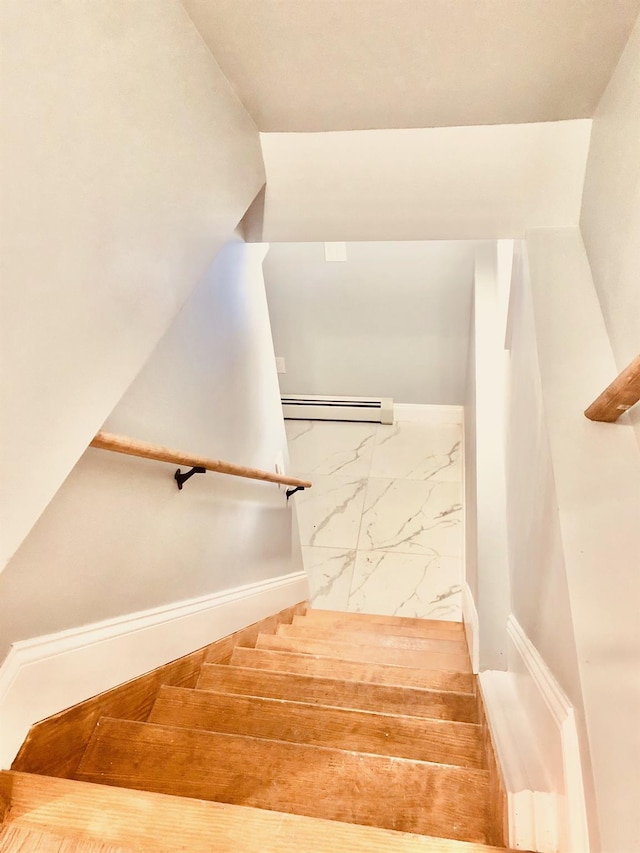 staircase featuring baseboard heating