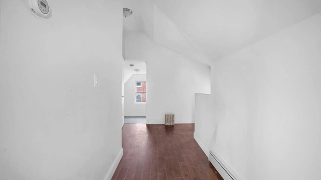 hall featuring lofted ceiling, a baseboard heating unit, and dark hardwood / wood-style flooring