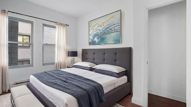 bedroom with dark wood-type flooring