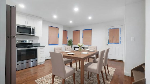 dining space featuring dark hardwood / wood-style flooring