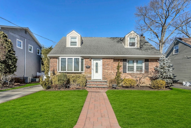 cape cod house featuring central AC and a front lawn