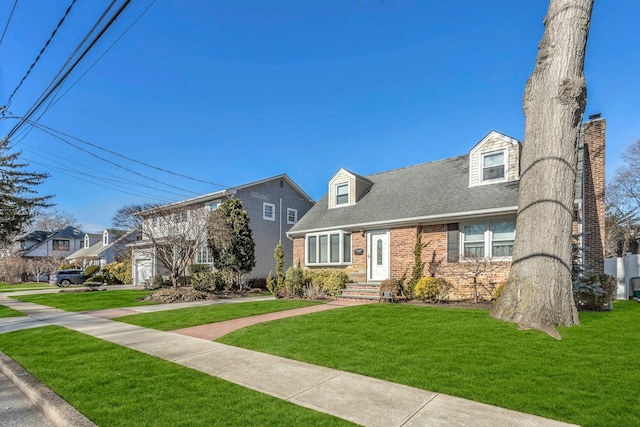 cape cod home featuring a front yard