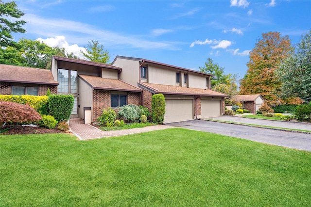 view of property featuring a garage and a front yard