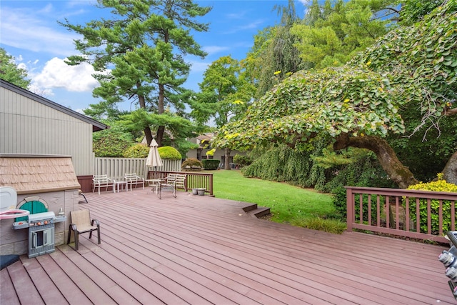 deck with grilling area and a lawn