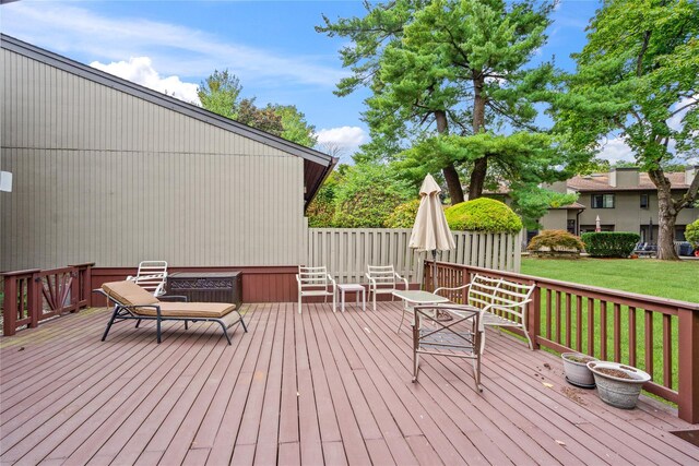 wooden terrace featuring a yard