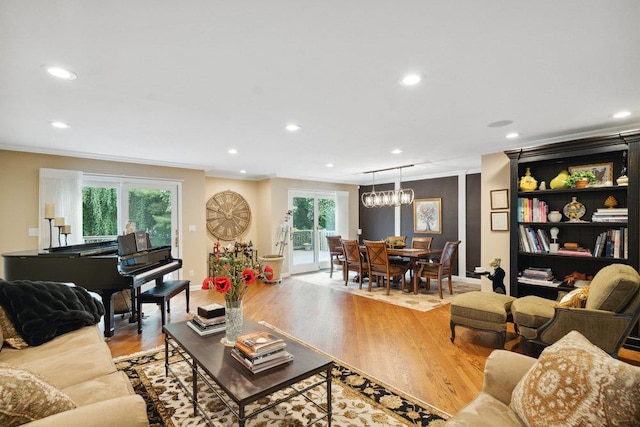 living room featuring ornamental molding and light wood-type flooring