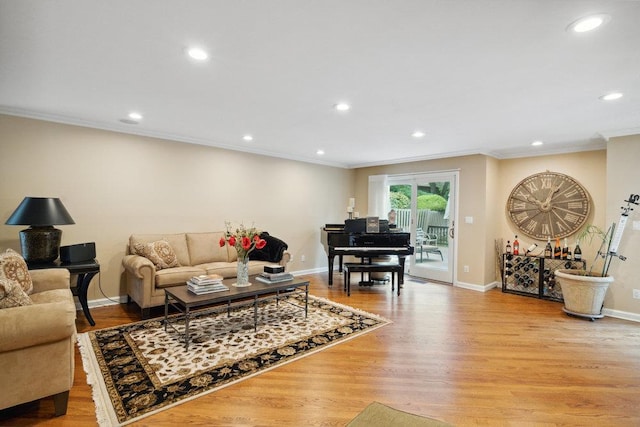 living room with light hardwood / wood-style flooring and ornamental molding