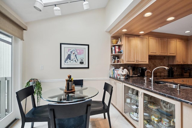 tiled dining room featuring sink