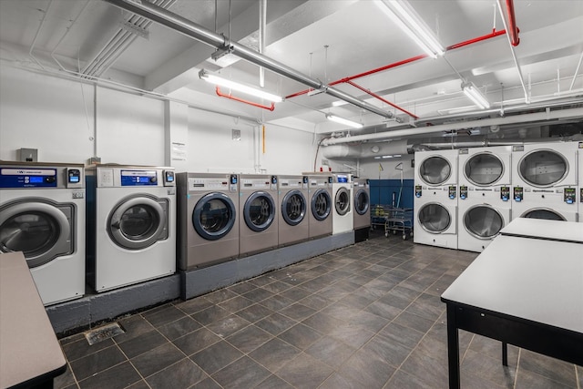 washroom featuring stacked washer and dryer and washing machine and dryer