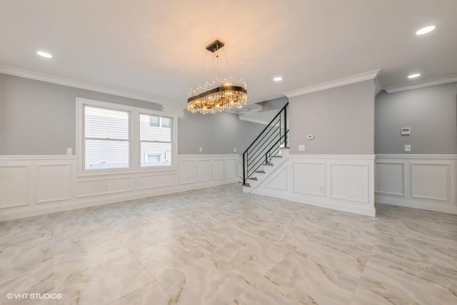 unfurnished room featuring an inviting chandelier and ornamental molding