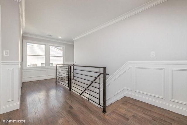 stairs featuring crown molding and wood-type flooring