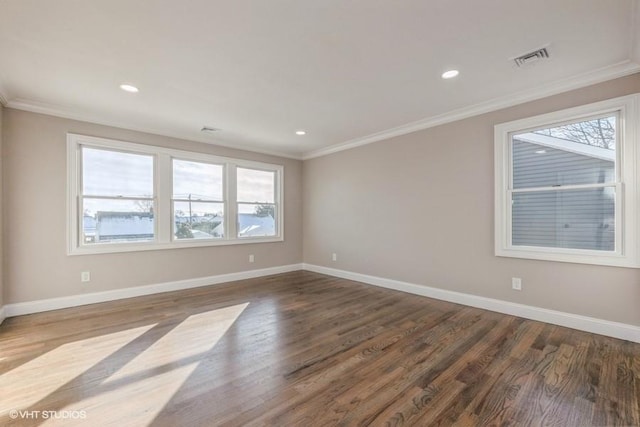 empty room featuring hardwood / wood-style floors and ornamental molding