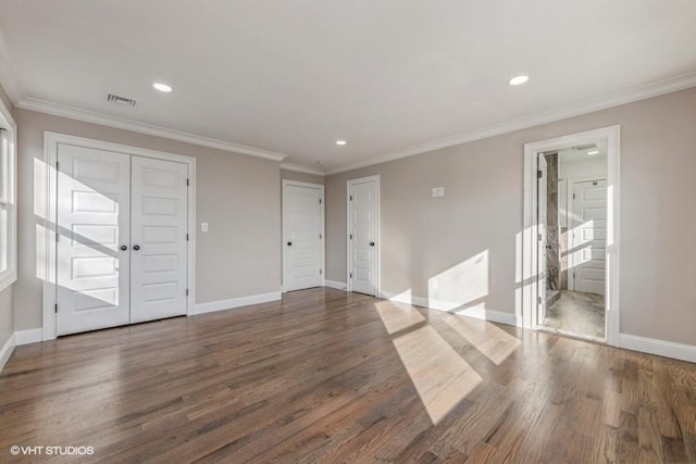 unfurnished room featuring crown molding and dark wood-type flooring