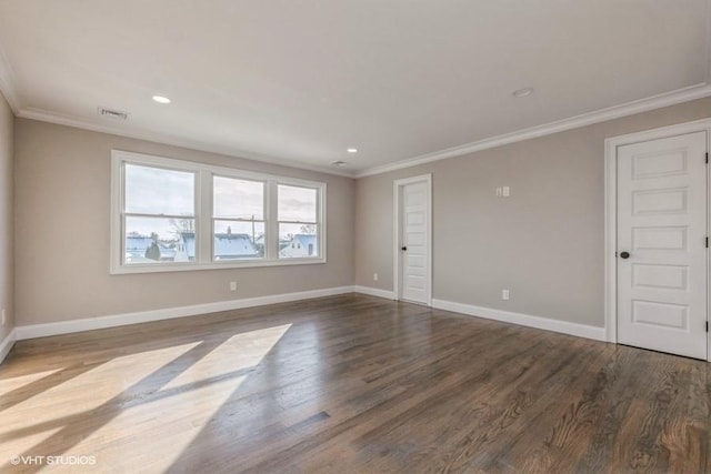 empty room featuring hardwood / wood-style floors and crown molding