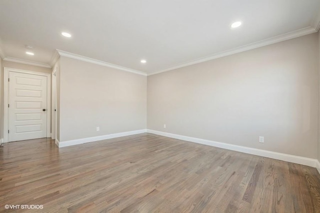 empty room featuring ornamental molding and light wood-type flooring