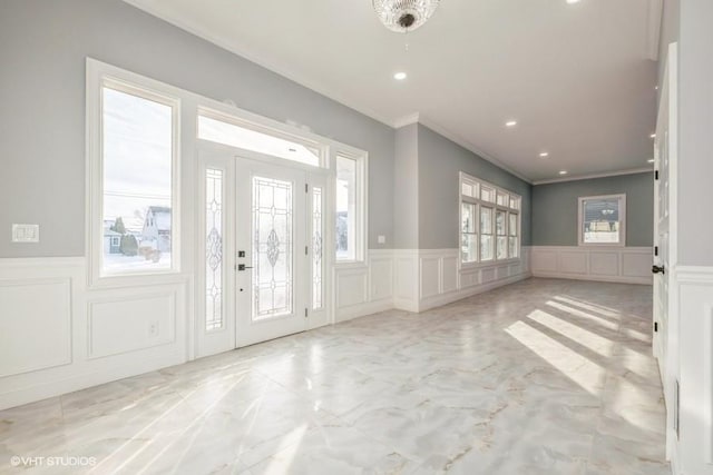 entrance foyer featuring ornamental molding