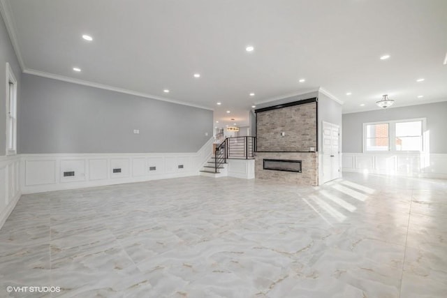 unfurnished living room featuring crown molding and a fireplace