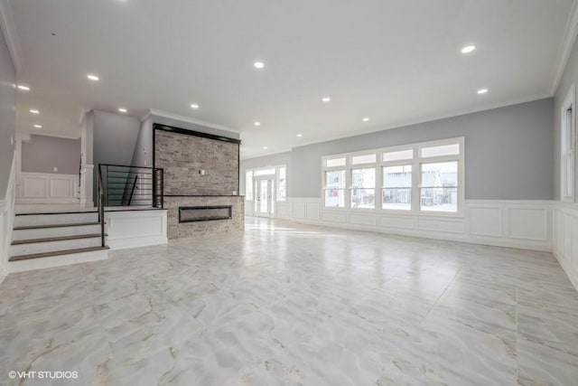 unfurnished living room featuring a fireplace and ornamental molding