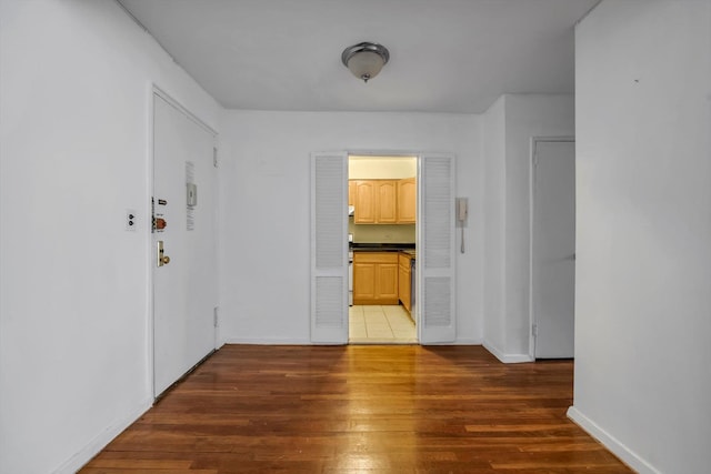 corridor featuring dark wood-type flooring