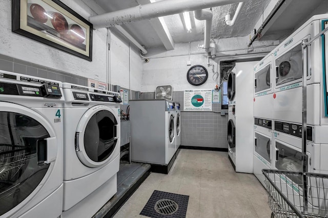 clothes washing area with washing machine and dryer and stacked washer and clothes dryer