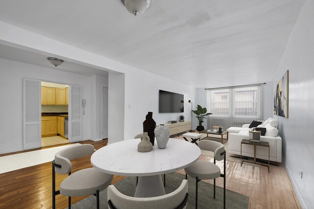 67-41 Burns St Unit 212, Forest Hills, NY 11375 - dining room with light wood-style flooring and baseboards