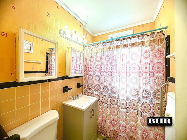 bathroom featuring tasteful backsplash, tile walls, vanity, toilet, and crown molding