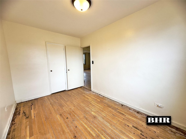unfurnished bedroom featuring baseboards and light wood-style floors