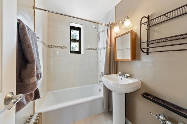 bathroom featuring tiled shower / bath, tile patterned floors, sink, and radiator heating unit