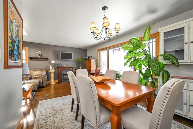 dining area with an inviting chandelier and hardwood / wood-style floors