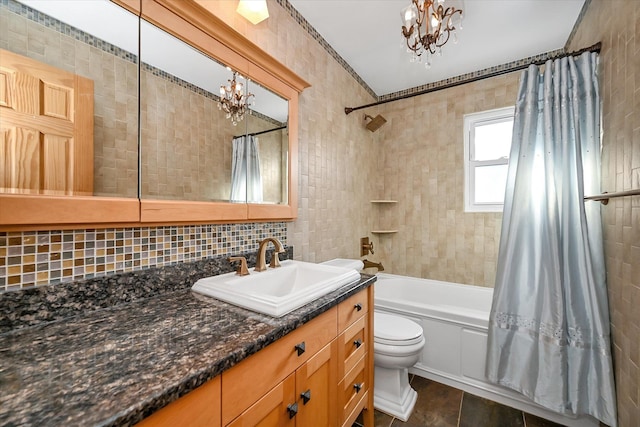 full bathroom featuring vanity, a notable chandelier, toilet, and shower / bath combo with shower curtain