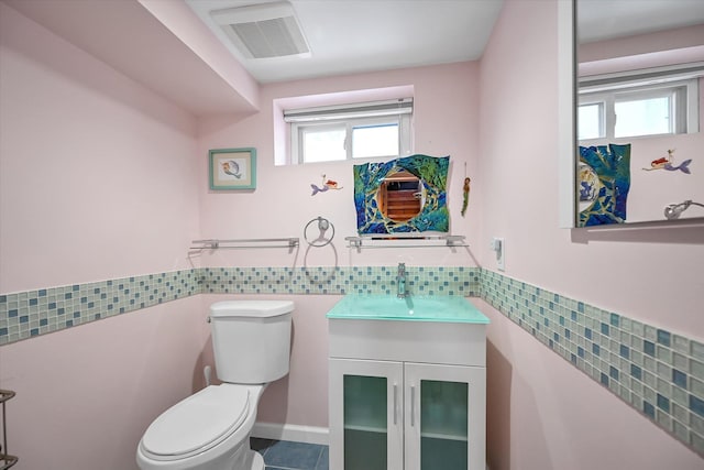 bathroom featuring vanity, tile patterned floors, and toilet