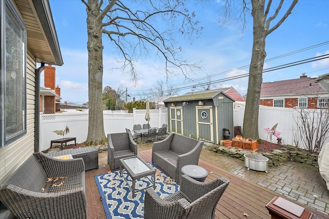 wooden deck featuring an outdoor hangout area, a patio area, and a storage unit