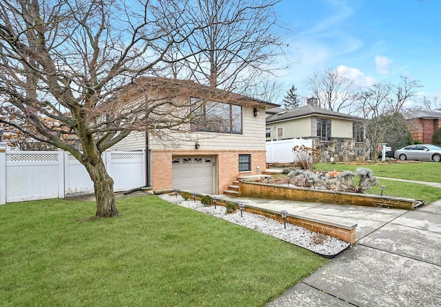 split level home with a garage and a front yard