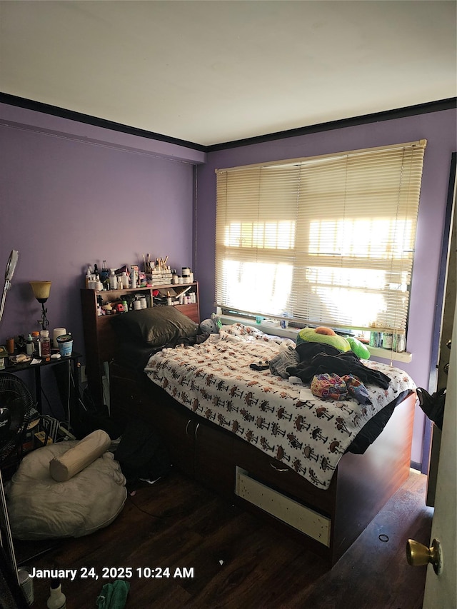 bedroom featuring crown molding and dark hardwood / wood-style flooring