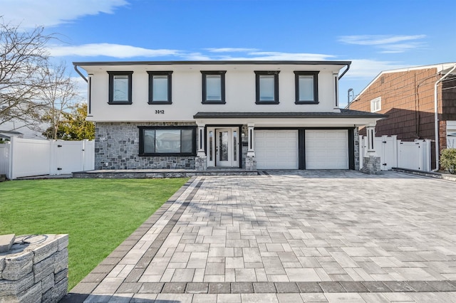 view of front of property featuring a garage and a front lawn