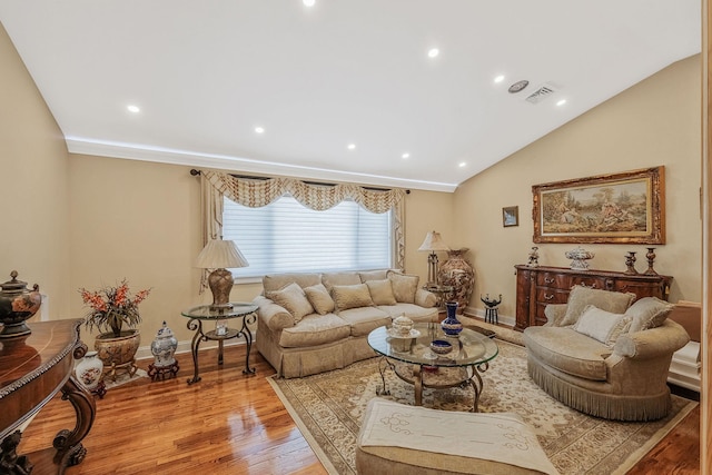 living room with lofted ceiling and light hardwood / wood-style floors