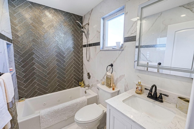 full bathroom with tiled shower / bath, tile walls, vanity, and toilet