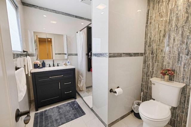 bathroom featuring a wealth of natural light, tile walls, vanity, tile patterned floors, and a shower with curtain