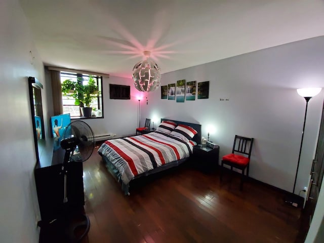 bedroom with dark hardwood / wood-style flooring