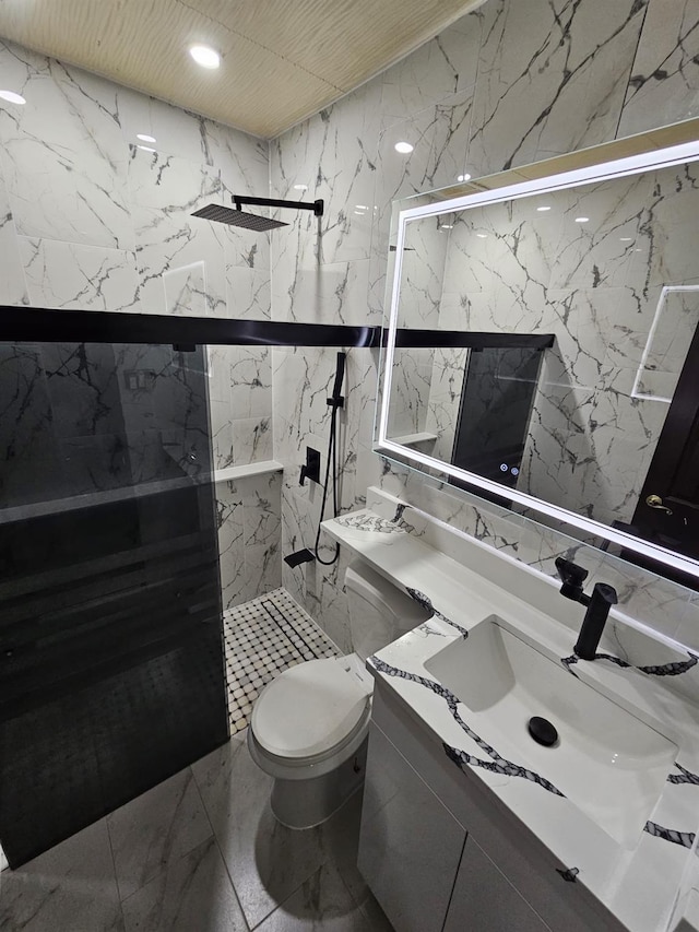 bathroom featuring vanity, toilet, tile walls, and a shower with shower door