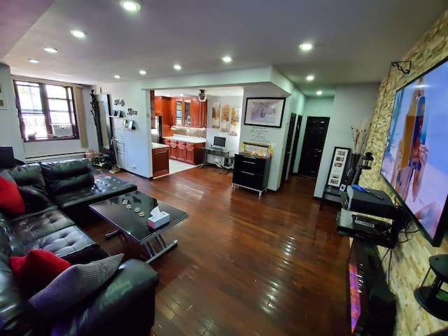 living room featuring dark wood-type flooring and baseboard heating