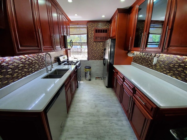 kitchen featuring stainless steel appliances, sink, and backsplash