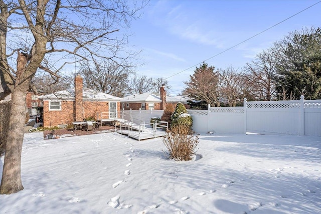 view of yard layered in snow